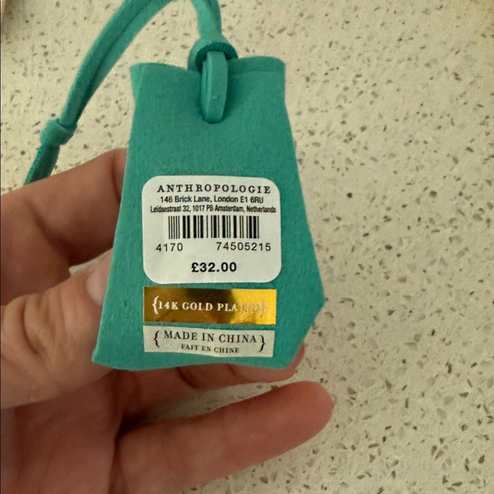 Anthropologie Turquoise Leather holder with Rings.